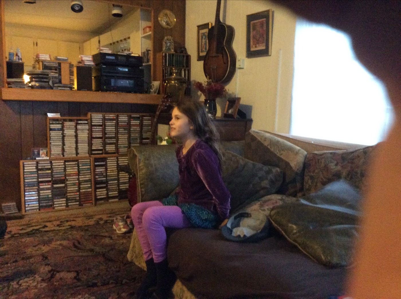 A child curled up on a sofa