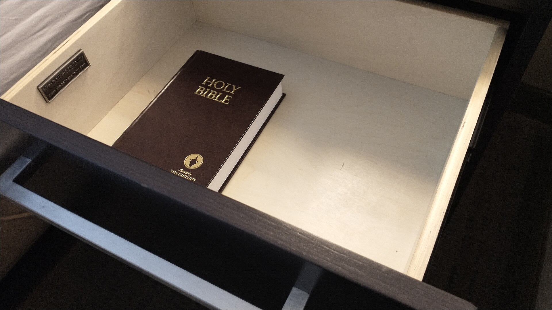 A Holy Bible resting in a hotel drawer